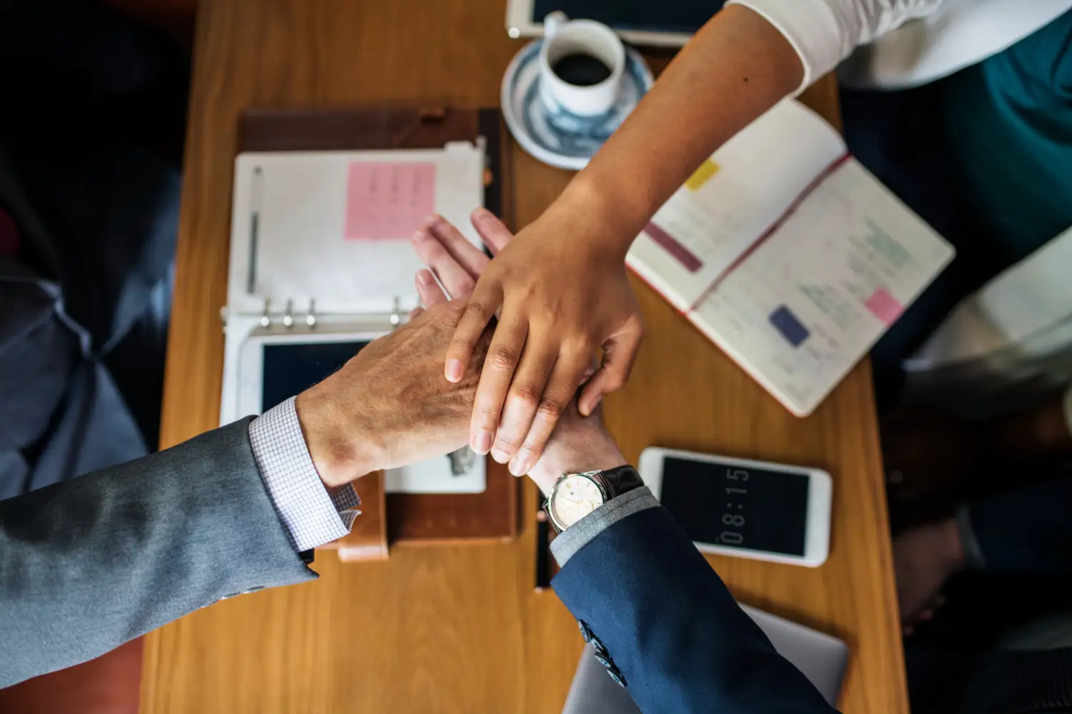 CPQ Software for all Stakeholders people stacking hands over a table