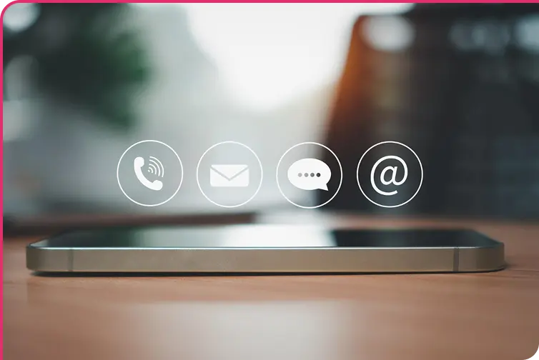 mobile phone on table with phone, mail, message, and at symbol floating above it mobile phone on table with phone, mail, message, and at symbol floating above it