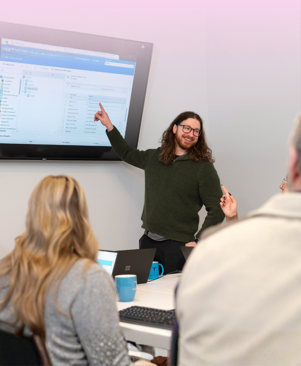 Drew Training three cpq professional women and one man huddling around a laptop and working